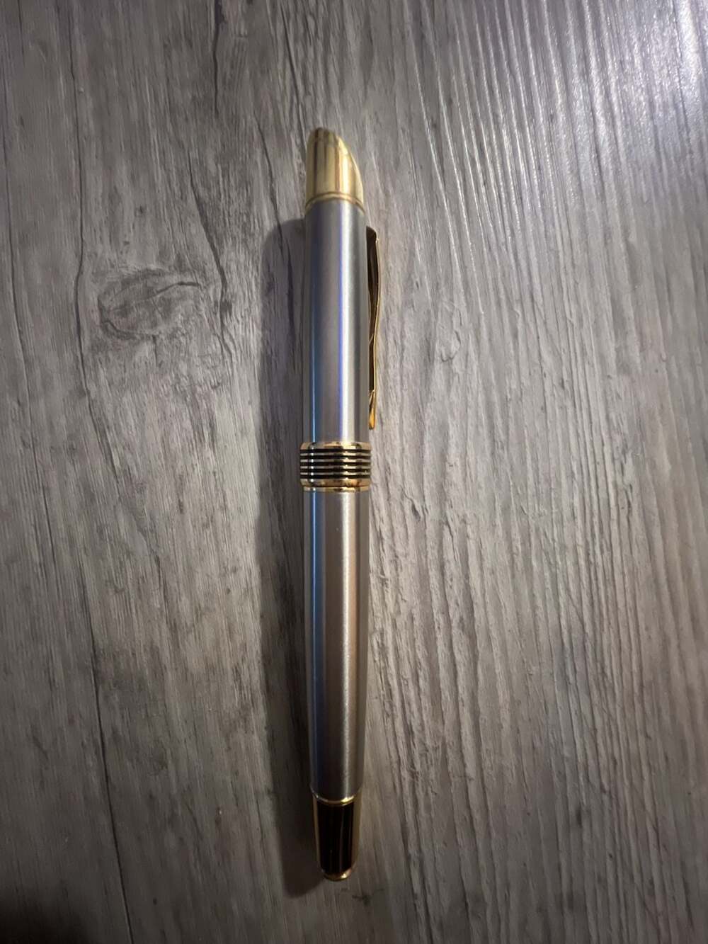 Cross Bailey Rollerball Pen in Chrome with Gold Trim. Writes well. + 1 extra new